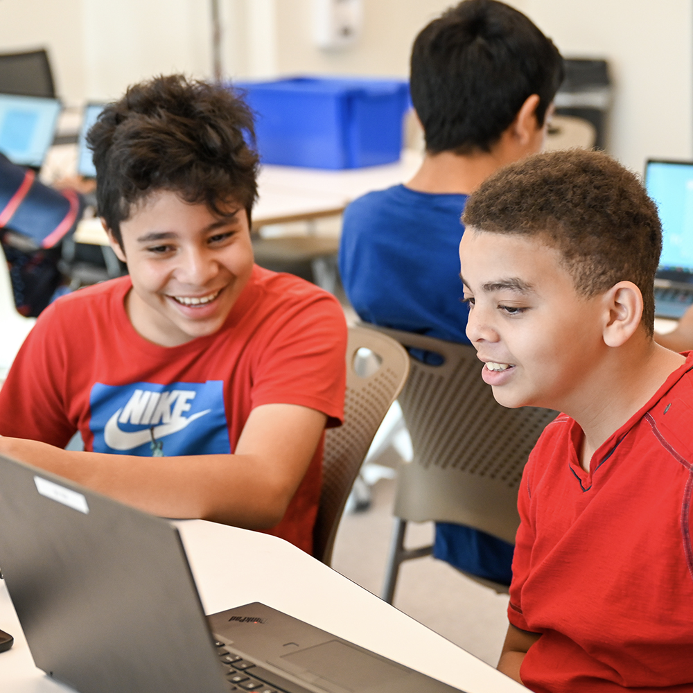 Boys looking at computer at the TGR Learning lab in Anaheim, CA