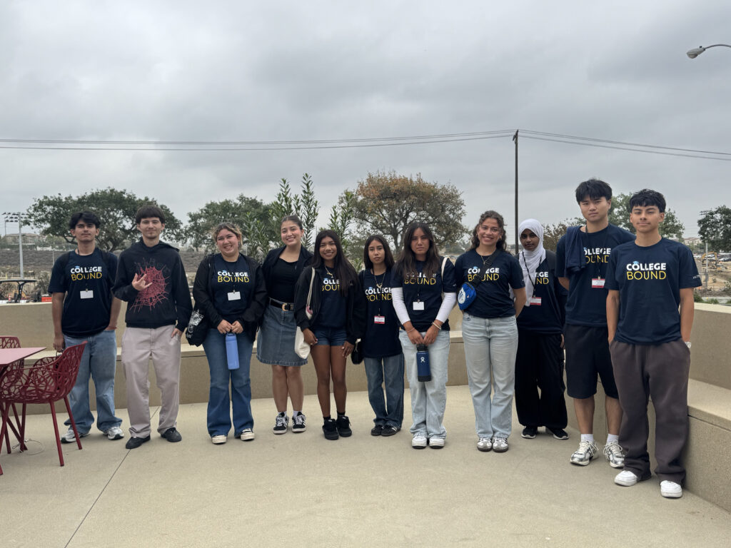 Group of students standing in a row outdoors on a cloudy day, wearing matching 'College Bound' shirts and name badges.