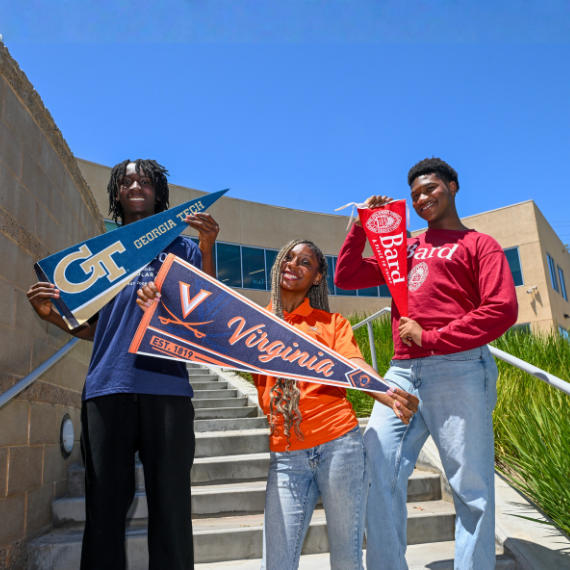 Three diverse students on campus steps, holding college banners for Georgia Tech, University of Virginia, and Bard College.