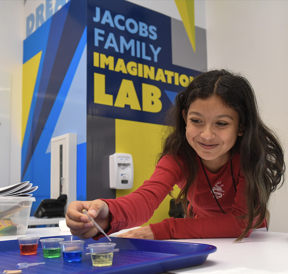 Female student working in the Jacobs Family Imagination lab room during the school day programming.